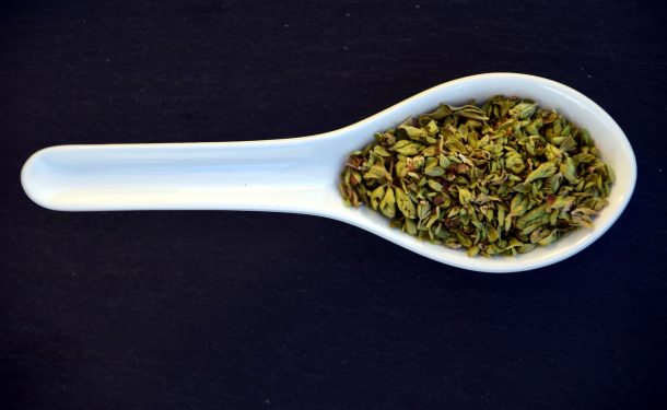 Dried italian oregano in a spoon